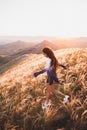Happy young woman running in sunset light. Freedom concept Royalty Free Stock Photo