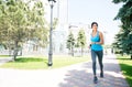 Happy young woman running outdoors Royalty Free Stock Photo