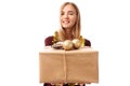 Happy young woman in Santa Claus hat, in hands, a gift box on a