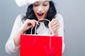 Happy young woman with santa hat holding a shopping bag Royalty Free Stock Photo