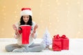 Happy young woman with santa hat holding a shopping bag Royalty Free Stock Photo