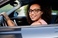 Happy young woman seated in her new car Royalty Free Stock Photo