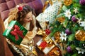 Happy young woman shaking green Christmas present box Royalty Free Stock Photo