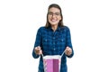 Happy young woman with a shopping bag, on white background, caucasian female with glasses and casual shirt