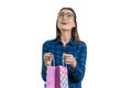 Happy young woman with a shopping bag, on white background, caucasian female with glasses and casual shirt