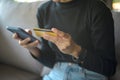 Happy young woman is shopping online via smart phone , holding credit card Royalty Free Stock Photo