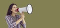 Happy young woman shouting into megaphone making announcement Royalty Free Stock Photo