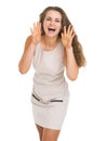 Happy young woman shouting through megaphone shaped hands Royalty Free Stock Photo