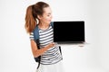 Happy young woman showing blank laptop screen Royalty Free Stock Photo