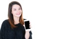 Happy young woman showing a blank screen mobile phone aside copy space isolated over white background Royalty Free Stock Photo