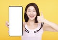 Happy Young woman  showing blank screen Smart phone and Thumbs up Royalty Free Stock Photo