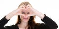 Happy young woman showing fingers love heart sign front eyes face with hand Royalty Free Stock Photo