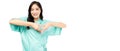 Happy young woman showing heart with two hands, love sign Cardiology patient use finger make heart shape over her chest and heart