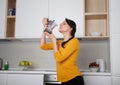 Happy Young woman showing moka pot