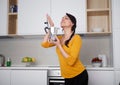 Happy Young woman showing moka pot