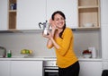 Happy Young woman showing moka pot