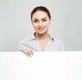 Happy young woman showing signboard with blank copyspace area for advertisiment or text message. Education and business concept