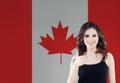 Happy young woman showing thumb up against the Canada flag background. Live, work, education and internship in Canada