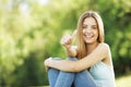 Happy young woman showing thumbs up sign