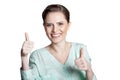 Happy young woman shows thumbs up isolated on white background Royalty Free Stock Photo