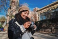 Happy young woman sightseeing on a jouney trip tacking pictures on holiday. Cute tourist photographer female watching