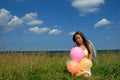 Happy young woman siting with colorful balloons