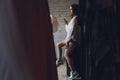 Happy young woman sitting at the clothing store with shopping bags and talking on mobile phone. Royalty Free Stock Photo