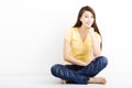 Happy young woman sitting on the floor Royalty Free Stock Photo