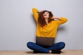 Happy young woman sitting and laughing with laptop computer Royalty Free Stock Photo