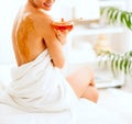 Young woman sitting on massage table with honey plate Royalty Free Stock Photo