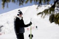 Young woman with ski equipment spending winter vacation at mountain resort Royalty Free Stock Photo