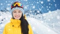 Happy young woman in ski goggles over mountains Royalty Free Stock Photo