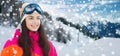 Happy young woman in ski goggles over mountains Royalty Free Stock Photo