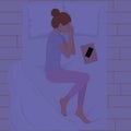 Happy young woman sleeping on pillows at night in pink pajamas top view. Young woman sleeping in bed with blanket, phone and book Royalty Free Stock Photo