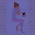 Happy young woman sleeping on pillows at night in pink pajamas top view. Young woman sleeping in bed with phone and book on bed Royalty Free Stock Photo