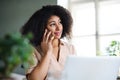 Happy young woman with smartphone working indoors at home, home office concept. Royalty Free Stock Photo