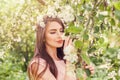 Happy Young Woman Smelling Flowers In Blossom Spring Flowers
