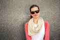 happy young woman is smiling with a blank wall outside with glasses