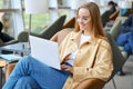 Happy young girl student using laptop computer sitting in university campus. Royalty Free Stock Photo