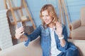 Happy young woman smiling while having a video call with a friend Royalty Free Stock Photo