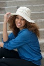 Happy young woman smiling outdoors with hat Royalty Free Stock Photo