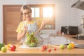 happy young woman smiling preparing vegetable salad in the kitchen. Healthy Food. Vegan Salad. Diet. Dieting Concept. Healthy Royalty Free Stock Photo