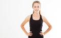 Happy young woman in sports clothing smiling. Fitness model on white background looking at camera at copy space