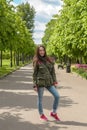 Happy young woman in sports clothing walking in summer Park Royalty Free Stock Photo