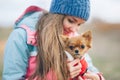 Happy young woman in spring clothes holding chihuahua puppy dog in animal wear Royalty Free Stock Photo