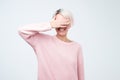 Happy young woman standing over grey background and covering eyes. She is waiting for proposal or gift Royalty Free Stock Photo