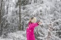 Happy young woman standing in snow blizzard with her arms spread Royalty Free Stock Photo