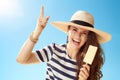 Happy woman against blue sky with ice cream on stick got idea Royalty Free Stock Photo