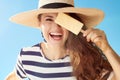 Happy woman against blue sky playing with ice cream on stick Royalty Free Stock Photo