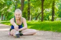 Happy young woman stretching before running outdoors Royalty Free Stock Photo